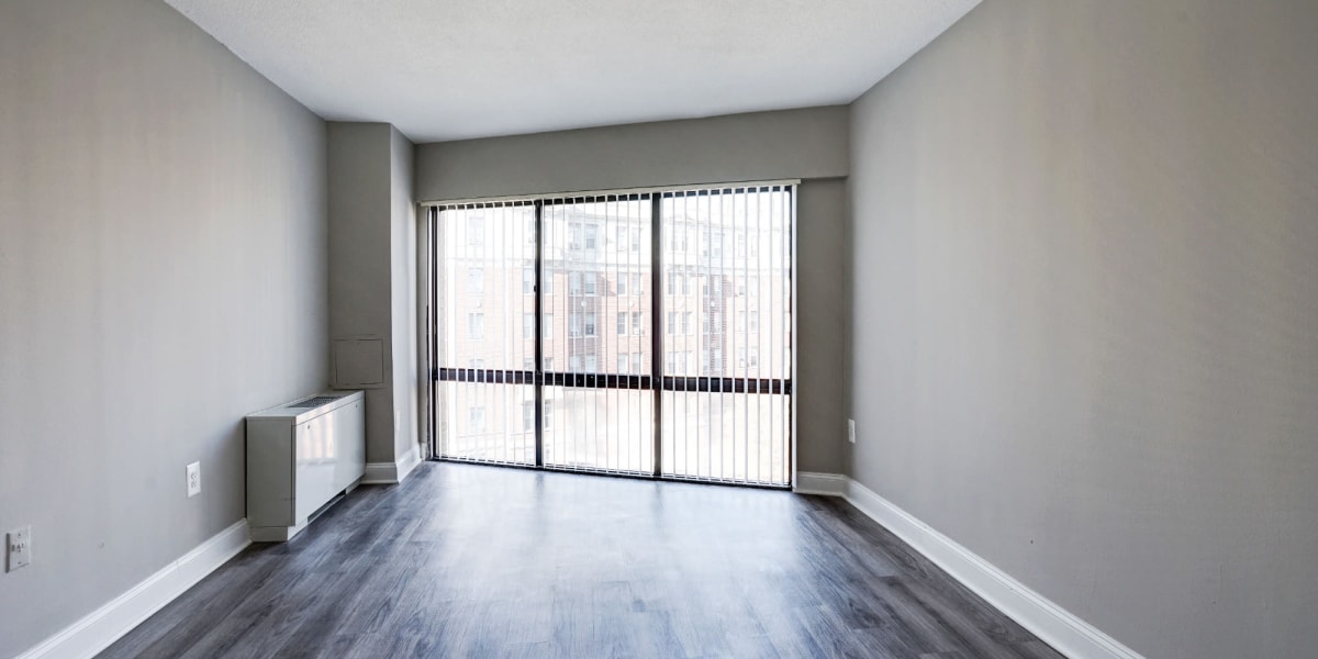 Very open bedroom with wood style flooring for an easy clean at The Cambridge Apartments in Washington, District of Columbia