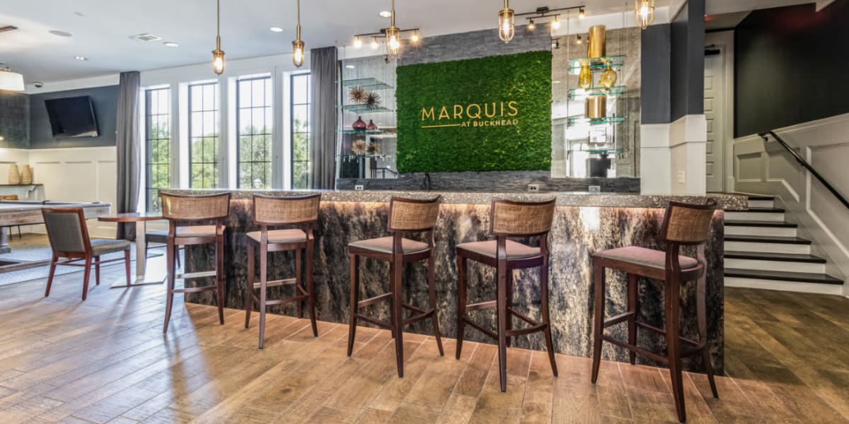 Indoor community room with counter seating and tall counter chairs at Marquis at Buckhead in Atlanta, Georgia