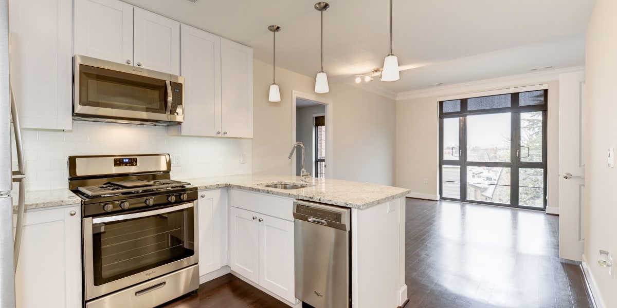 Beautiful white countertops and cabinets in the kitchen area at 700 Constitution in Washington, District of Columbia
