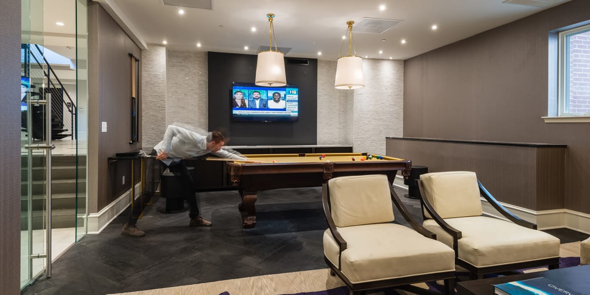 Clubhouse area with cozy chairs, a tv, and a pool table to play on at 700 Constitution in Washington, District of Columbia