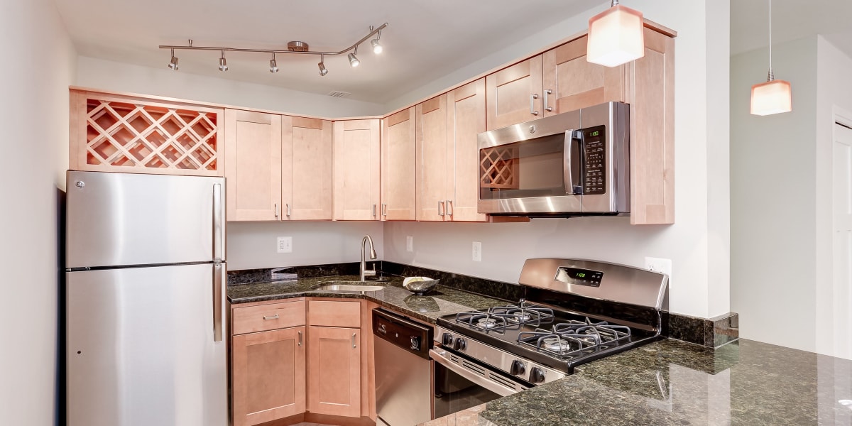 Stainless steal appliances in the kitchen with black countertops at Bristol House in Washington, District of Columbia