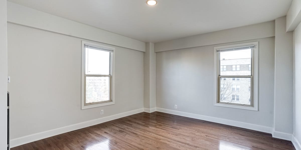 Unfurnished bedroom with two windows and wood style flooring at Dorchester House in Washington, District of Columbia