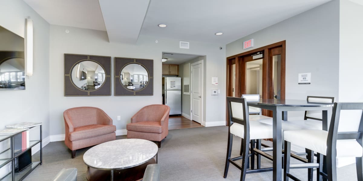 Cozy arm chairs and other places to sit in a common area for residents at Dorchester West in Washington, District of Columbia