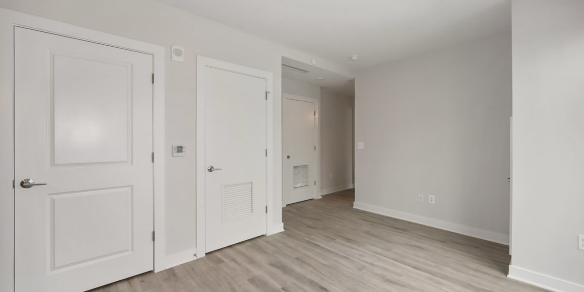 Bedroom area with wood style flooring and tons of natural light at Madrona Apartments in Washington, District of Columbia