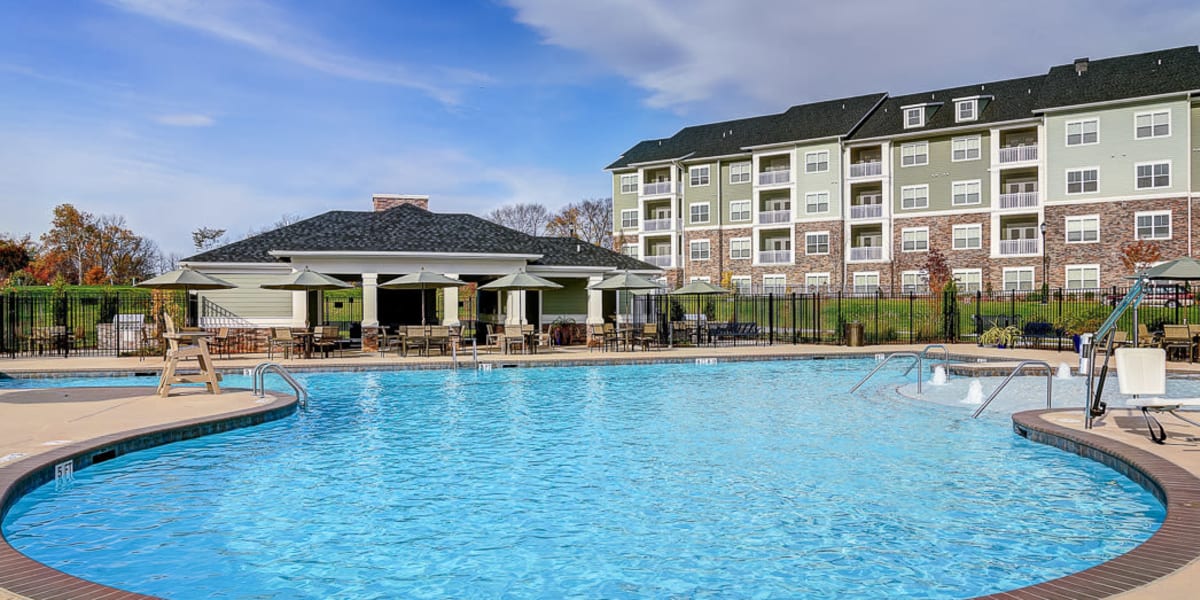 Resort style swimming pool with lounge chairs around it at The Retreat at Market Square in Frederick, Maryland