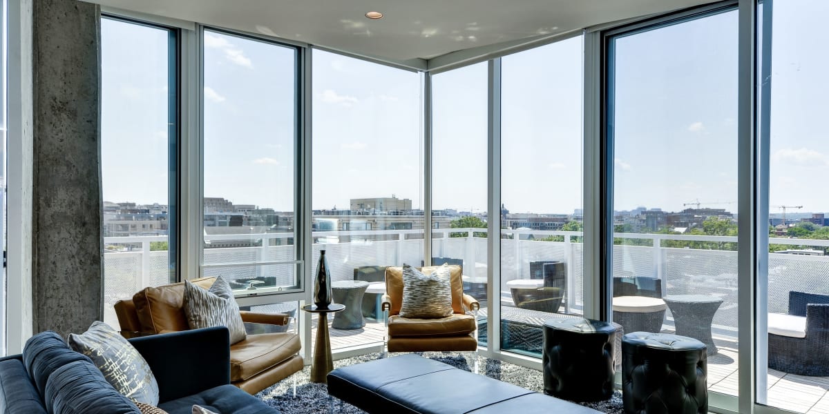 Resident can hang out in the sky lounge and enjoy this nice view and comfy couch at The Corcoran in Washington, District of Columbia