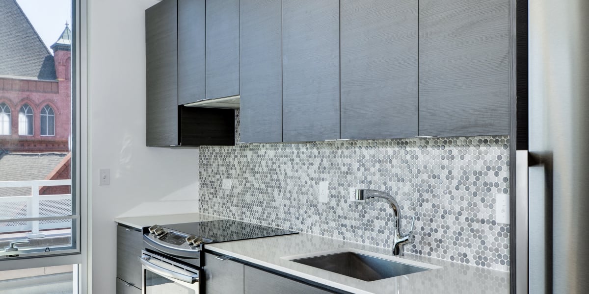 Modern kitchen with stainless steel appliances at The Corcoran in Washington, District of Columbia