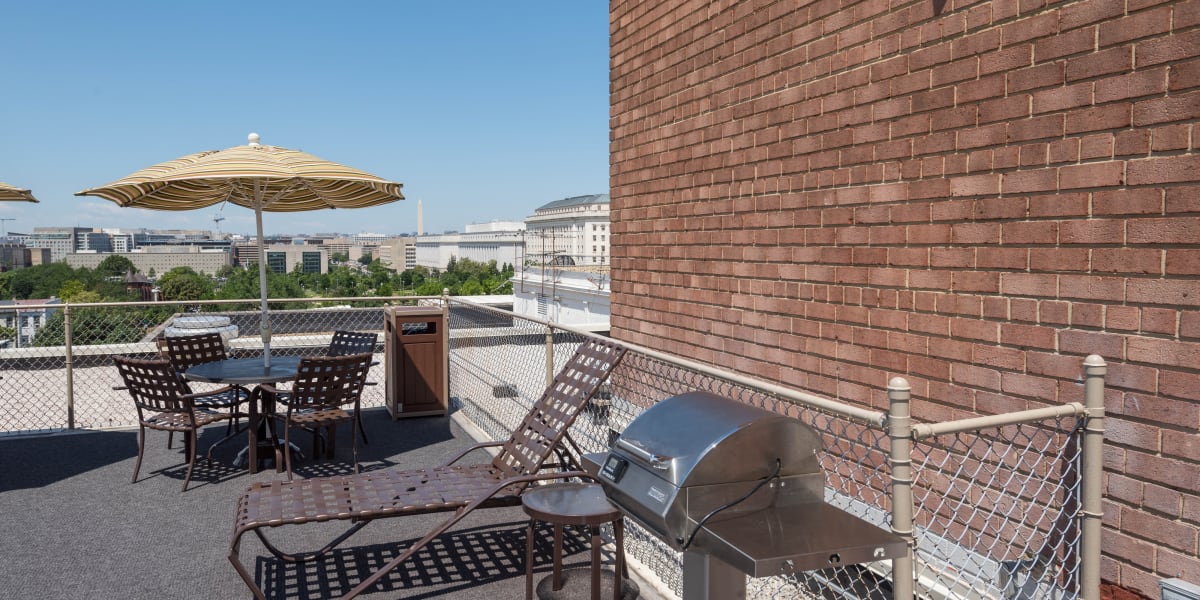 BBQ area on the rooftop patio for residents to cook and eat by at Hill House in Washington, District of Columbia