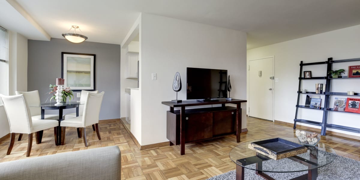 Model home with entertainment center and tv in the living room at The Brandywine Apartments in Washington, District of Columbia