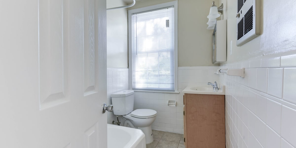 Cozy bathroom with lots of light and a large window at Chillum Manor in Washington, District of Columbia