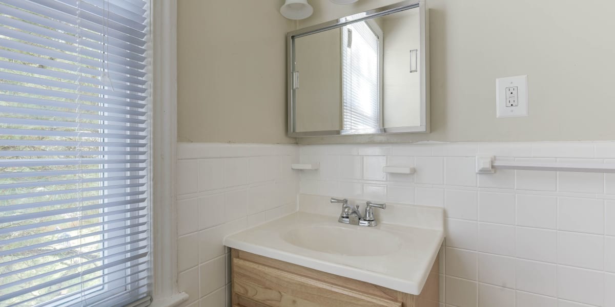 Cute vanity with a small mirror above it in the bathroom at Chillum Manor in Washington, District of Columbia
