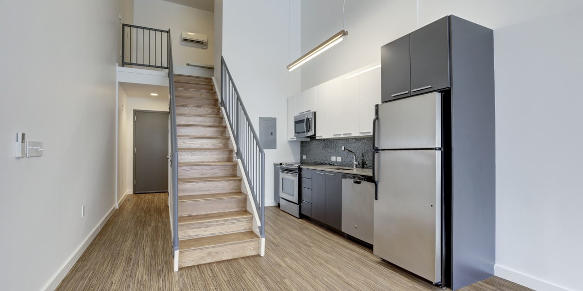 Very sleek looking kitchen with stairs going up to the loft at The Citadel in Washington, District of Columbia