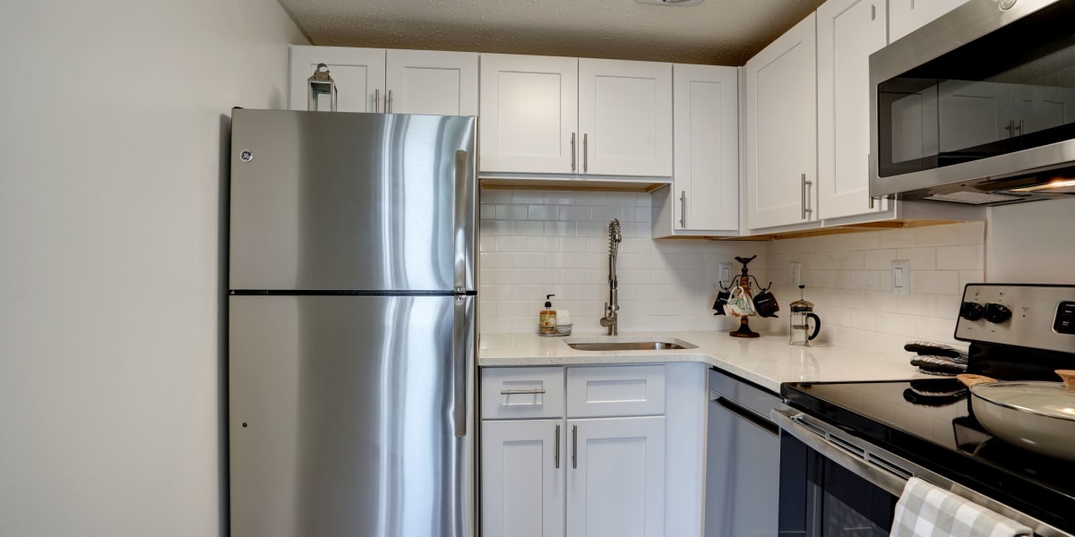 Stainless steel appliances in the modern kitchen area at The Envoy Apartments in Washington, District of Columbia