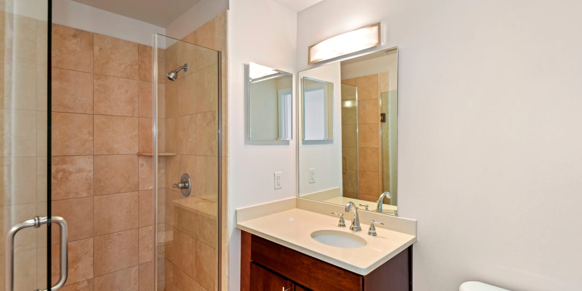 Cute vanity in the bathroom with a large mirror above it at Griffin Apartments in Washington, District of Columbia