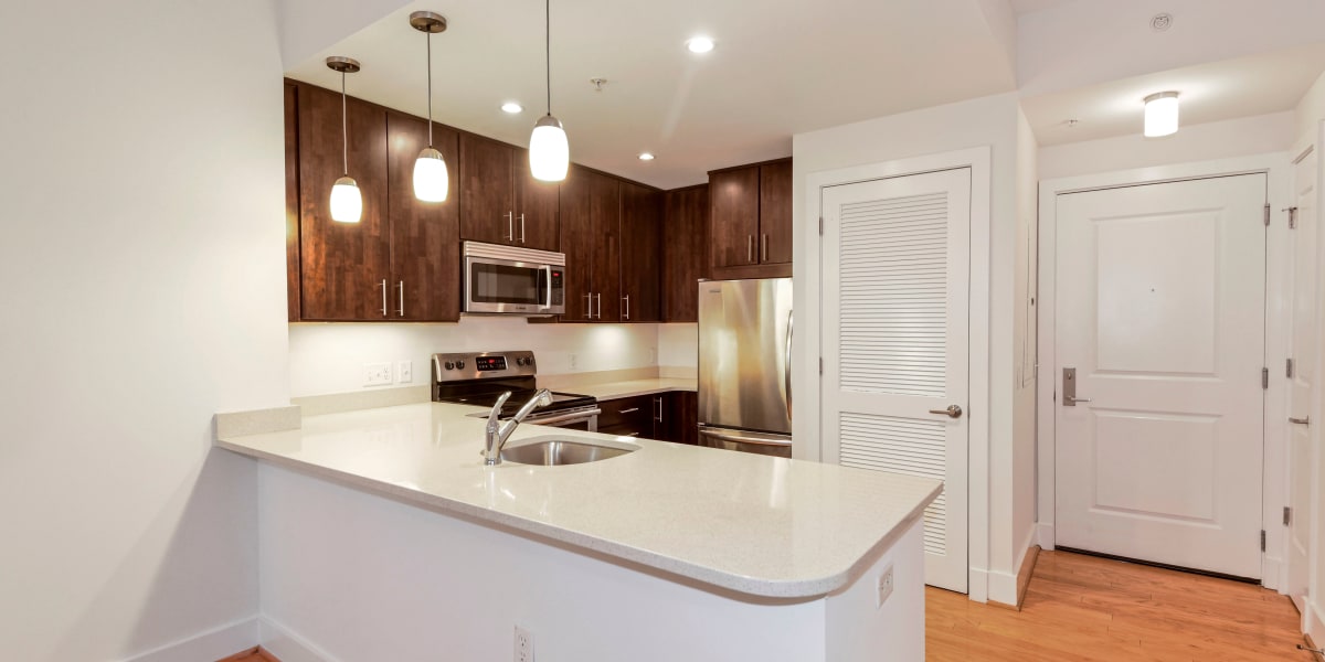 Very well lit kitchen with cool hanging lights above the breakfast bar at Griffin Apartments in Washington, District of Columbia
