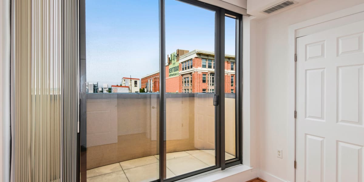 Floor to ceiling sliding glass door leading to the private patio at Griffin Apartments in Washington, District of Columbia