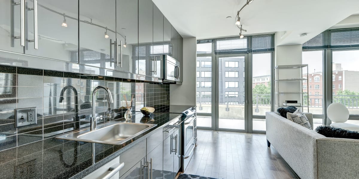 Very sleek looking kitchen area that has tons of large windows at The Bentley Apartments in Washington, District of Columbia