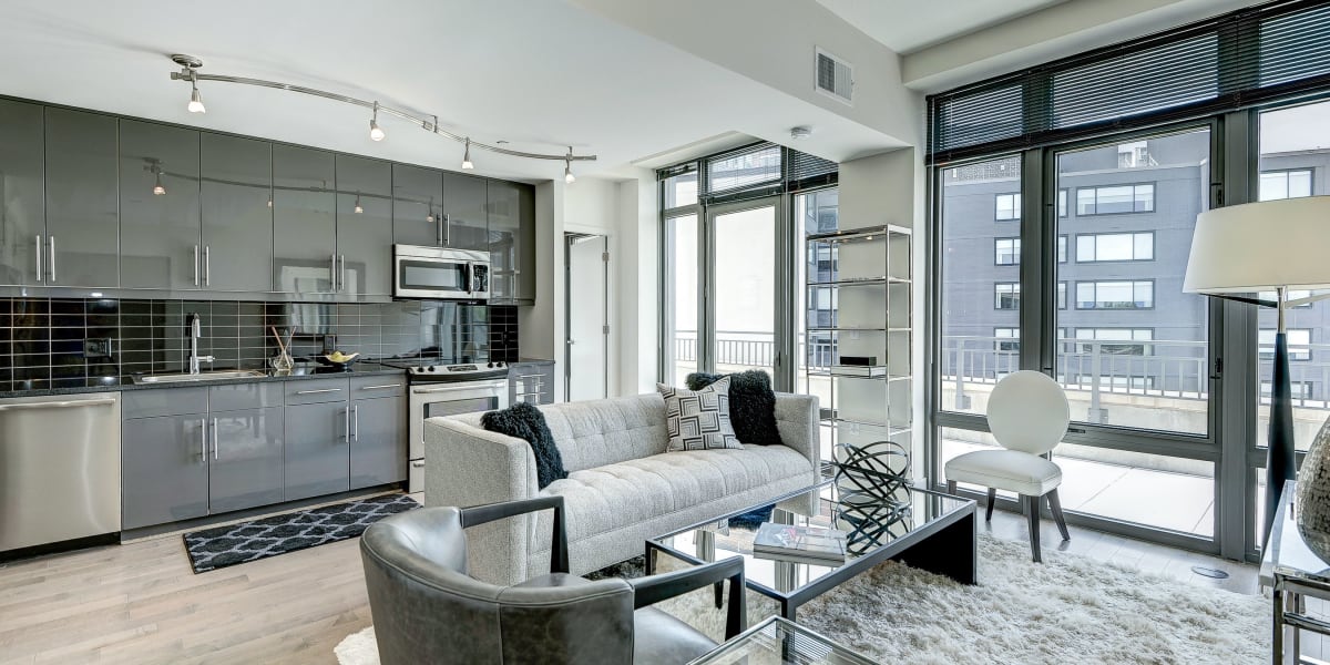 Open concept living area with a nice view out of the large windows at The Bentley Apartments in Washington, District of Columbia