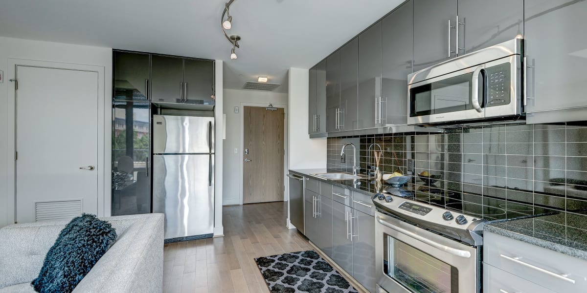 Stainless steal appliances and grey cabinets the compliment them nicely in the kitchen at The Bentley Apartments in Washington, District of Columbia