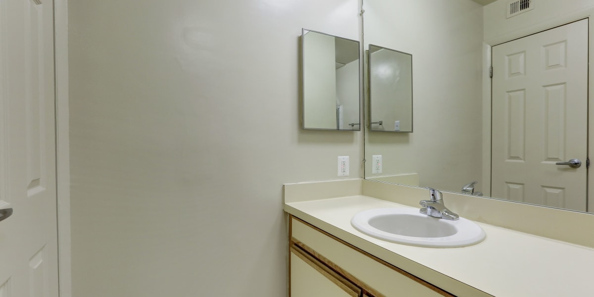 Large vanity mirror in the bathroom with lots of counter space on the vanity at Mayfair House in Falls Church, Virginia