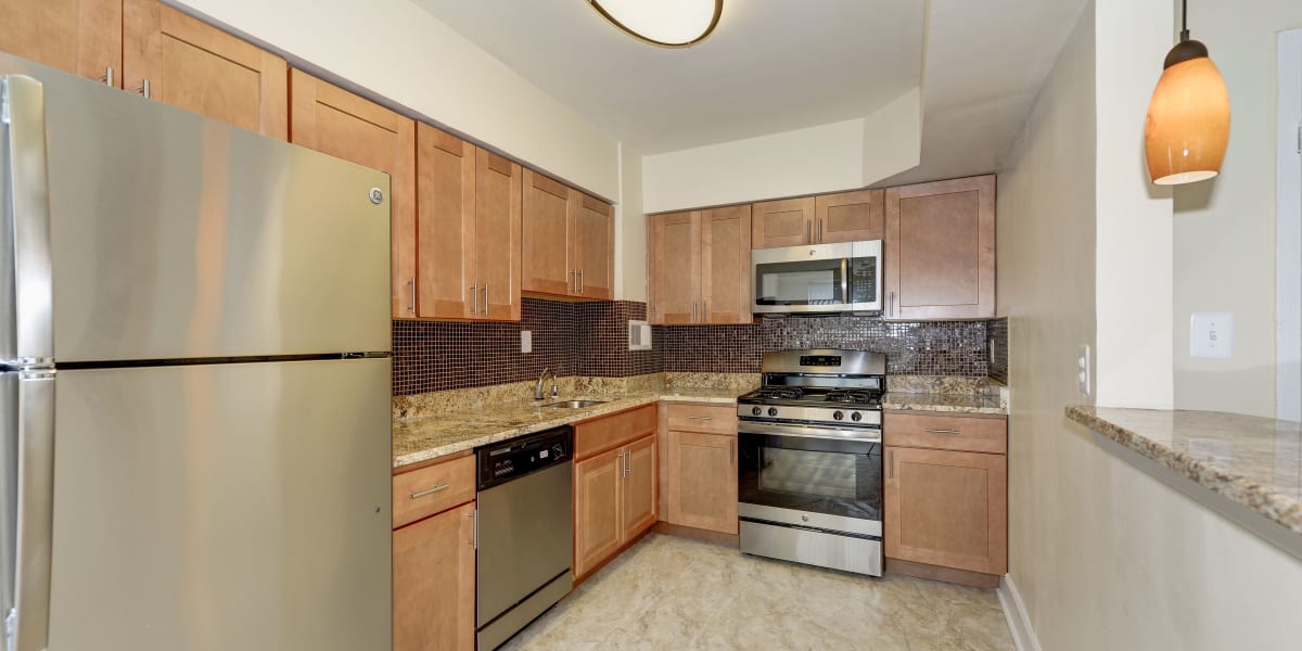 Light wood cabinets and stainless steel appliances in the kitchen at Michigan Park Commons in Washington, District of Columbia