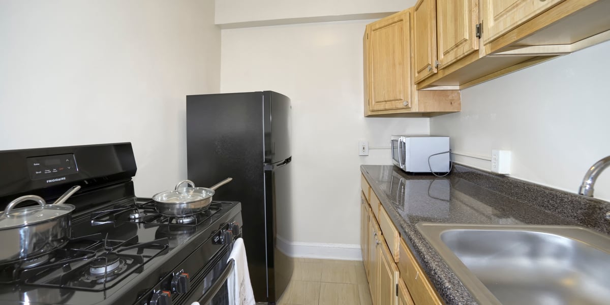 Black counters and appliances in the kitchen at The Normandie in Washington, District of Columbia