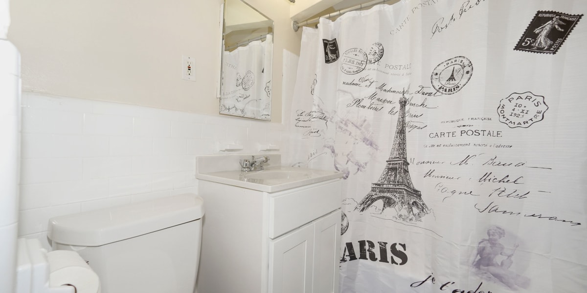 Shower curtain with a picture of the Eifel tower on it in the bathroom at The Normandie in Washington, District of Columbia