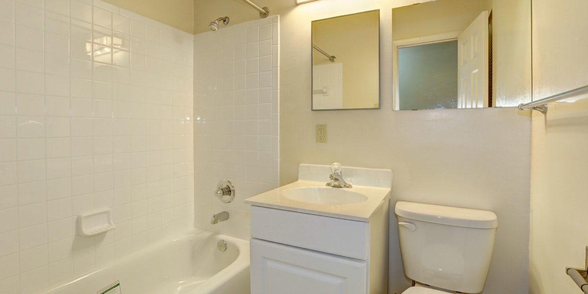 Cute bathroom with small vanity mirror and bath at Parkway Plaza in Washington, District of Columbia