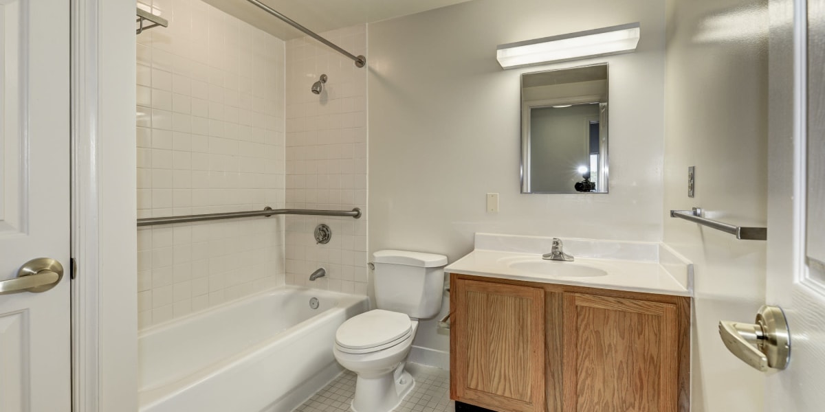Cute bathroom with vanity mirror and shower at The Delano in Adelphi, Maryland