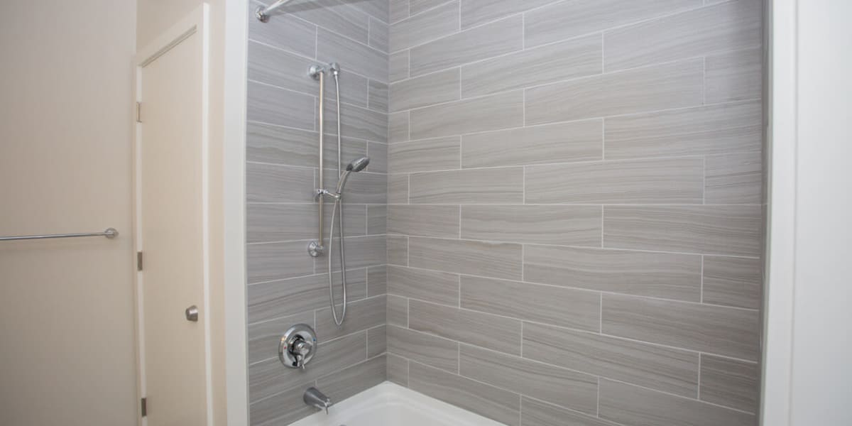 Very new looking shower with tile style walls at 3825 Georgia in Washington, District of Columbia