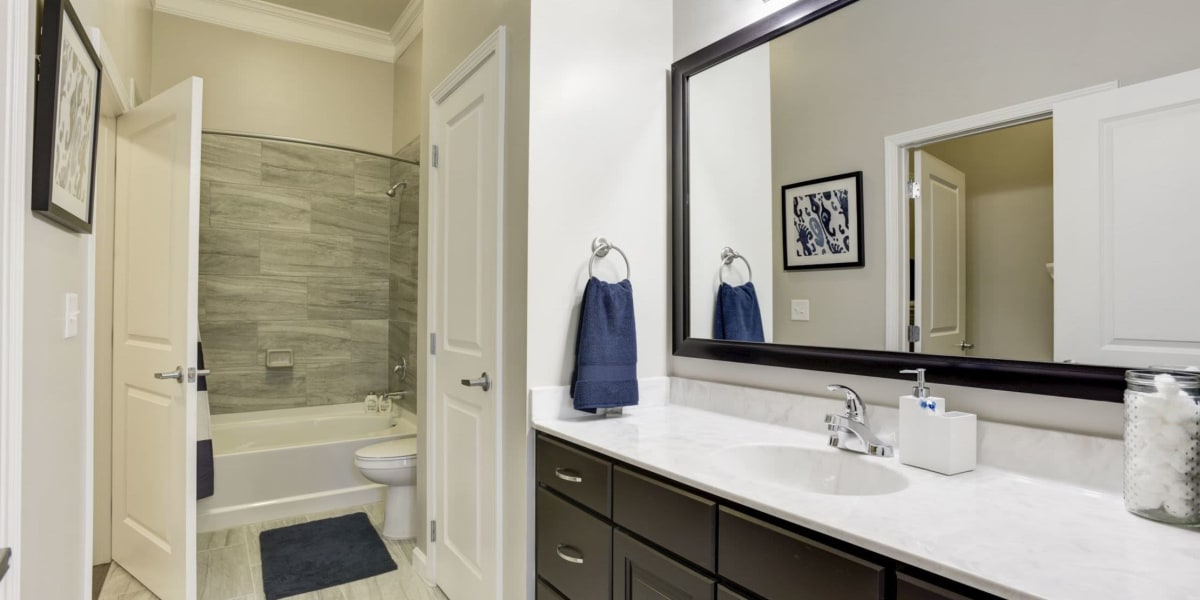 Spacious bathroom with large vanity mirror at Echelon at Odenton in Odenton, Maryland