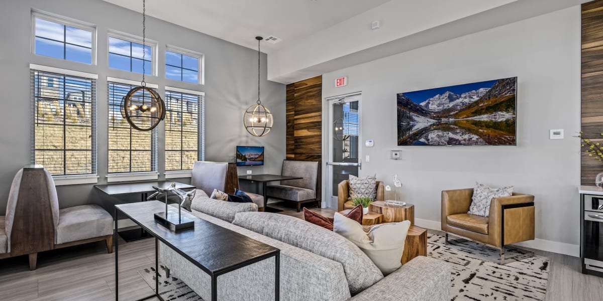 Well lit modern living room with wood floors at The Towne at Northgate Apartments in Colorado Springs, Colorado