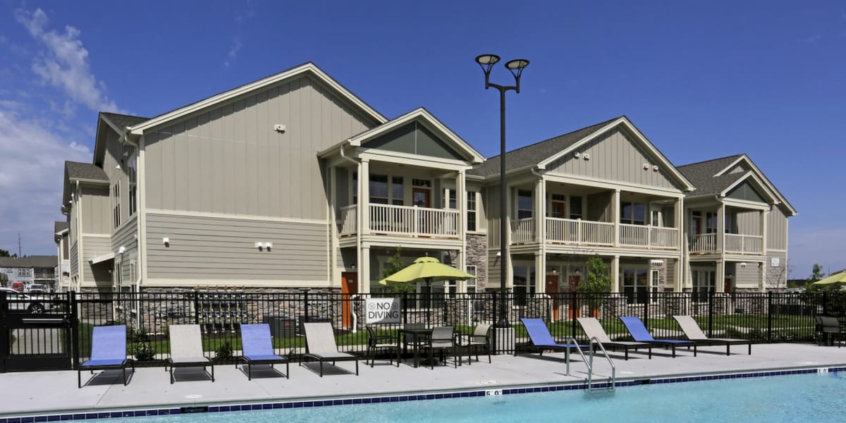 Gorgeous resort style pool with lounge chairs at The Towne at Northgate Apartments in Colorado Springs, Colorado