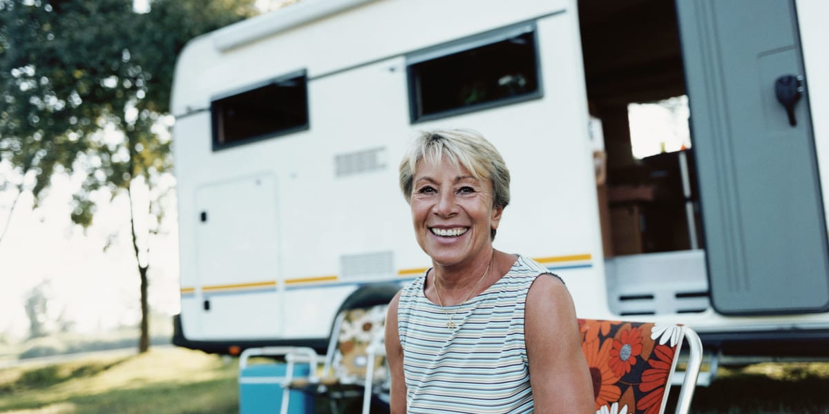 customer happily sitting in front of her rv at Comstock Covered RV Storage in Carson City, Nevada