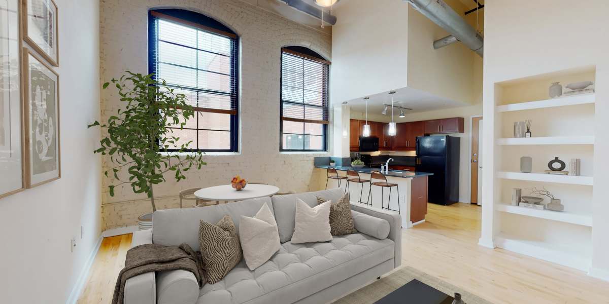 Living room with large windows in a model home at Perry Street Lofts in Petersburg, Virginia