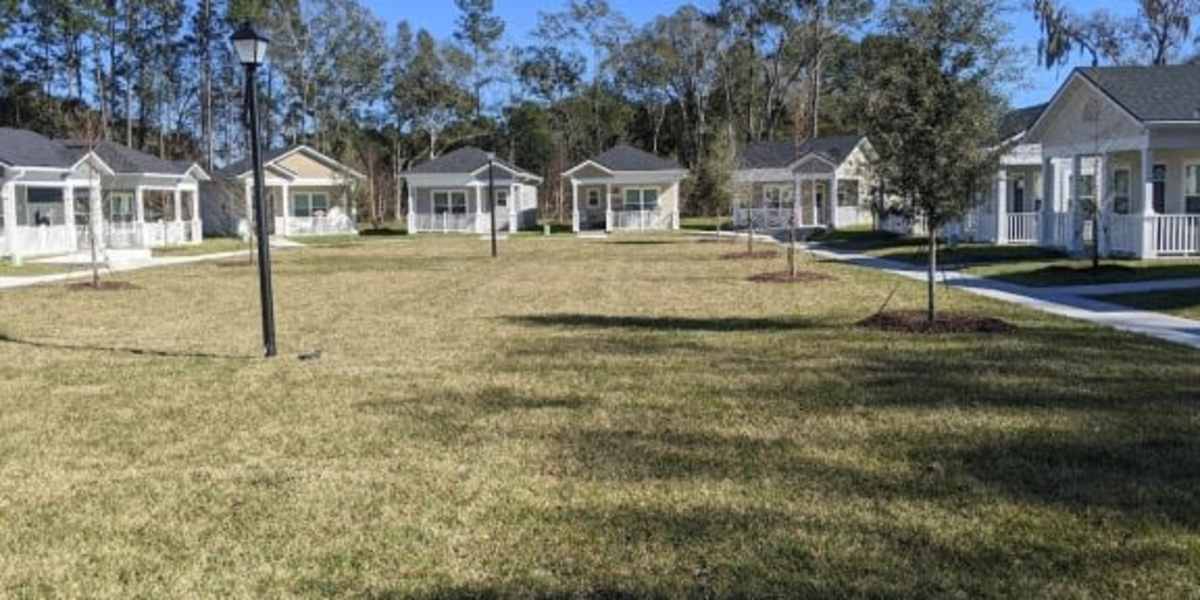 Lawn surrounded by apartment buildings at Tiny Houses on Navaho in Jacksonville, Florida