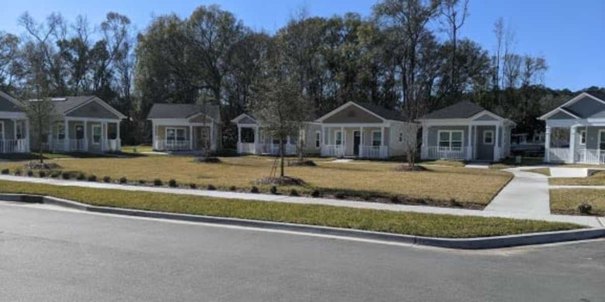  View of the apartment buildings and a path leading to the main door at Tiny Houses on Navaho in Jacksonville, Florida
