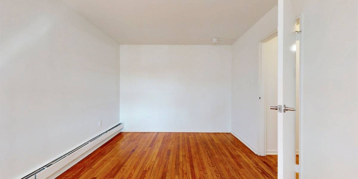 Gorgeous hardwood floors in the bedroom at Cherry Garden Apartments in Roselle, New Jersey