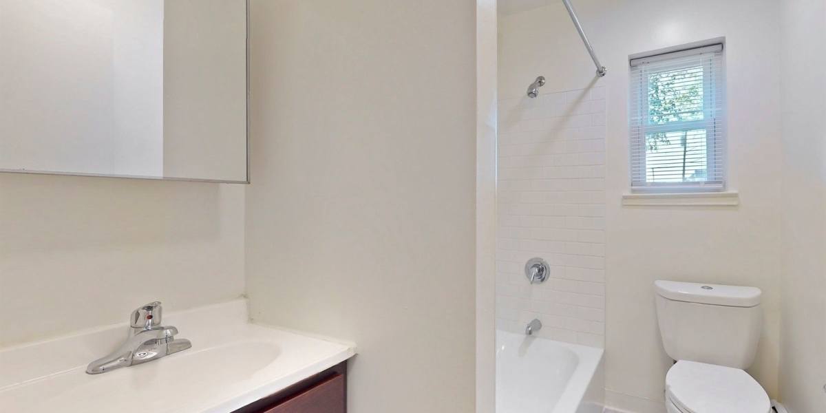Bathroom with mirror above the vanity at Cherry Garden Apartments in Roselle, New Jersey