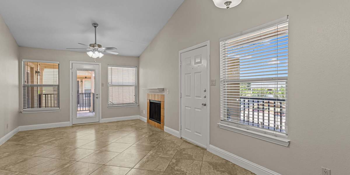 Living room looking at the fireplace and front door angle 3 at Courtyard Apartments And Storage in Granbury, Texas