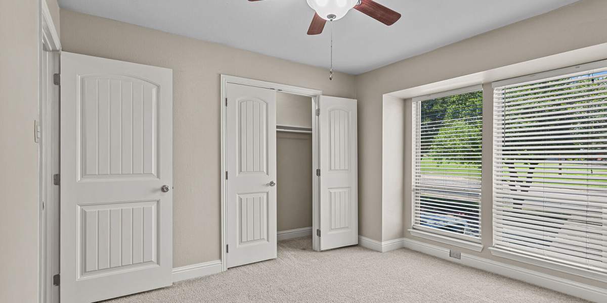 bedroom with 1 closet and a balcony at Courtyard Apartments And Storage in Granbury, Texas