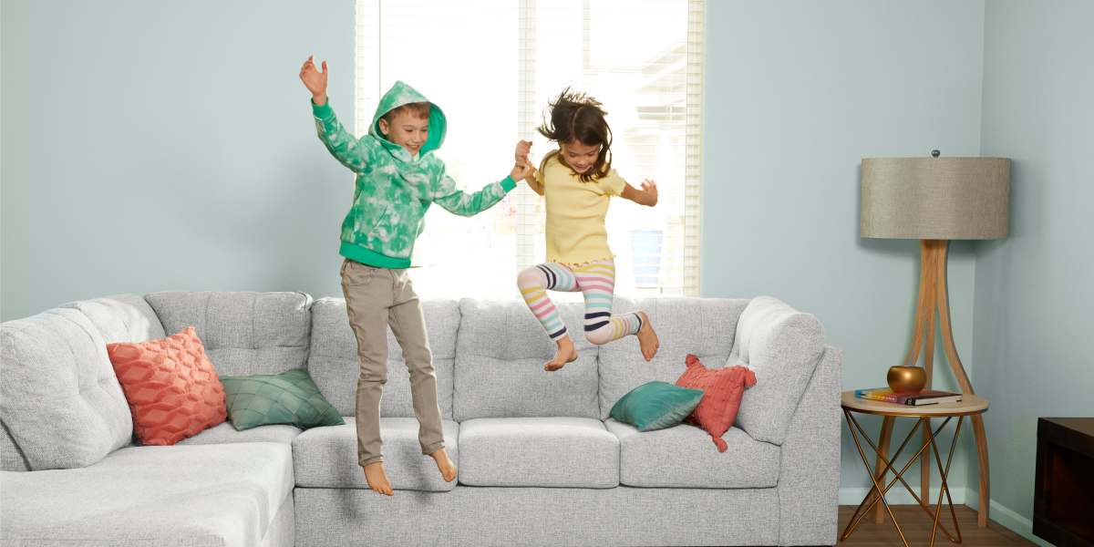 Kids jumping on the couch at BB Living Wellen Park in Venice, Florida