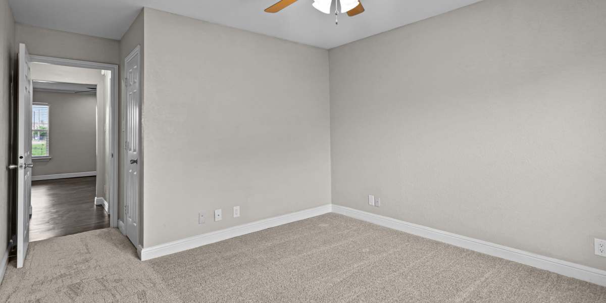 Carpeted bedroom angle 1 Towne Lake Apartments in Granbury, Texas
