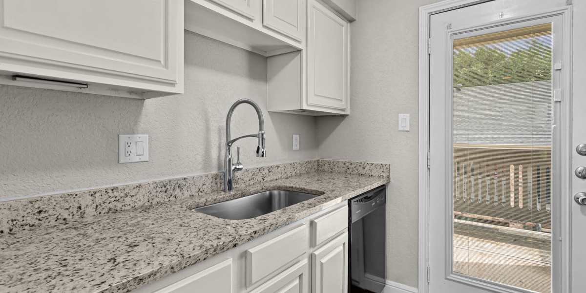 Apartment kitchen with a stainless steel sink Towne Lake Apartments in Granbury, Texas