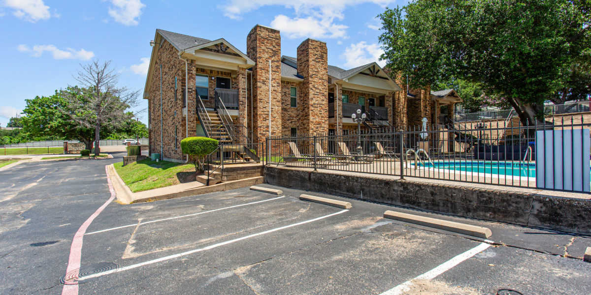 Parking by the pool at Towne Lake Apartments in Granbury, Texas