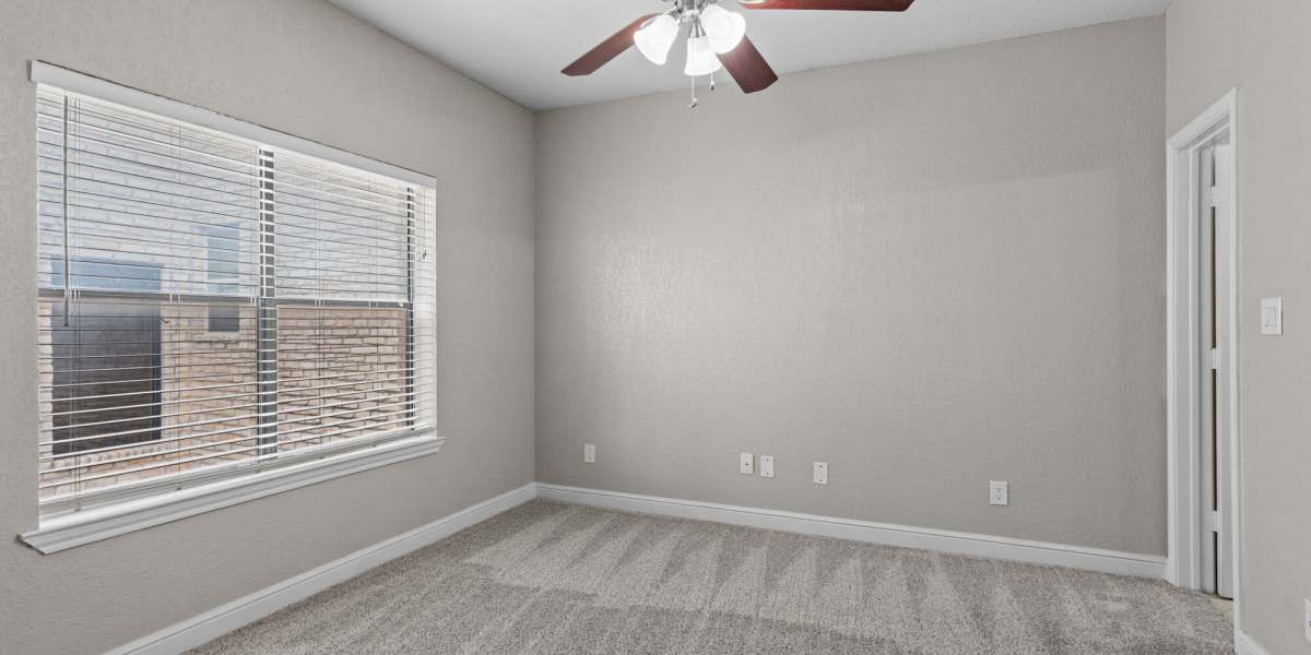 Carpeted apartment bedroom at Towne Square Condos at The Lodge in Granbury, Texas
