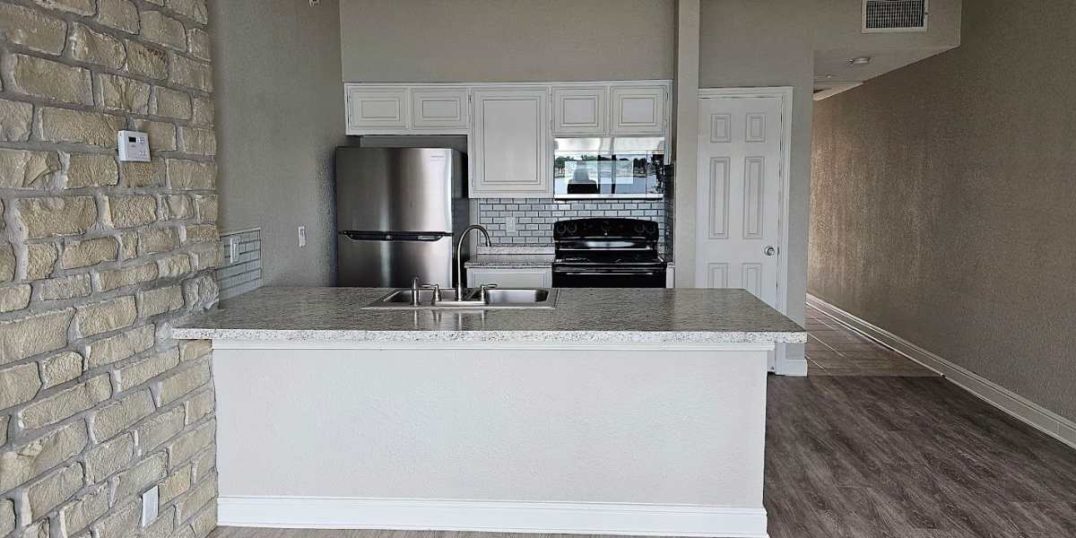 Kitchen alcove with a brick wall at Towne Square Condos at The Lodge in Granbury, Texas