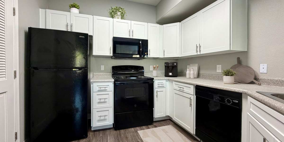 Renovated kitchen with white cabinets at The Lofts in Sacramento, California