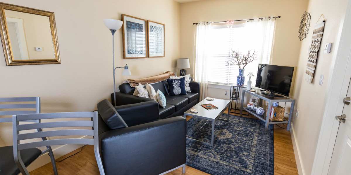 A living room with a large window at Beacon Springfield in Springfield, Missouri