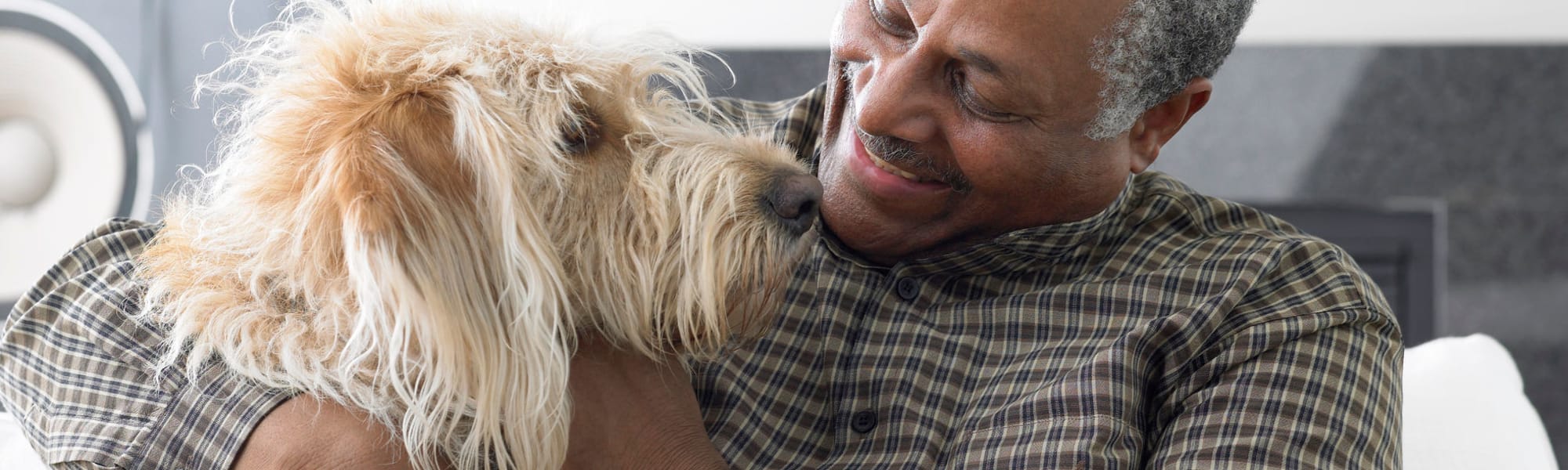 Resident  hugging dog at The Blake at LPGA building in Daytona Beach, Florida